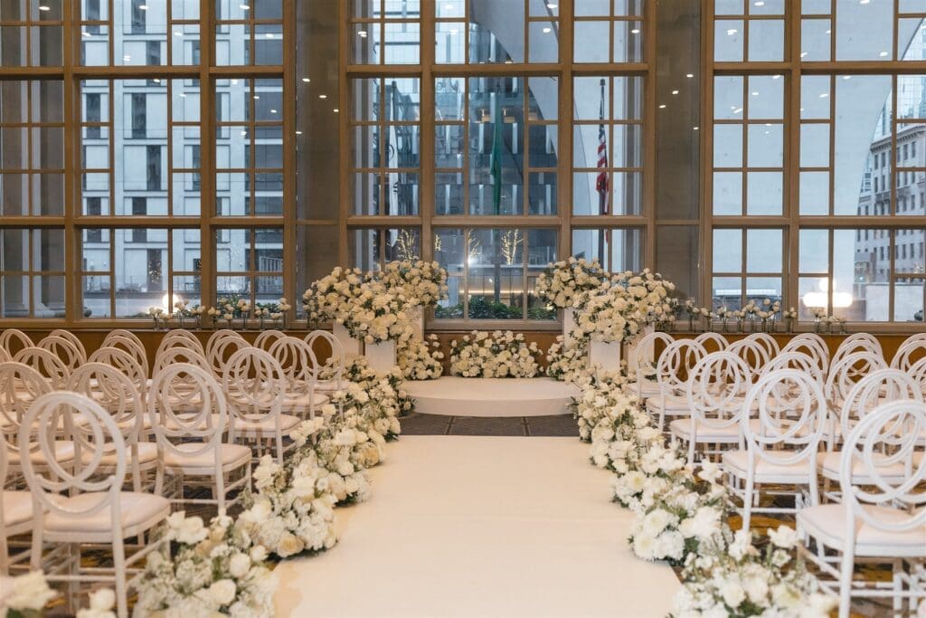 Luxury black-tie wedding cermony in Seattle with white floral installations