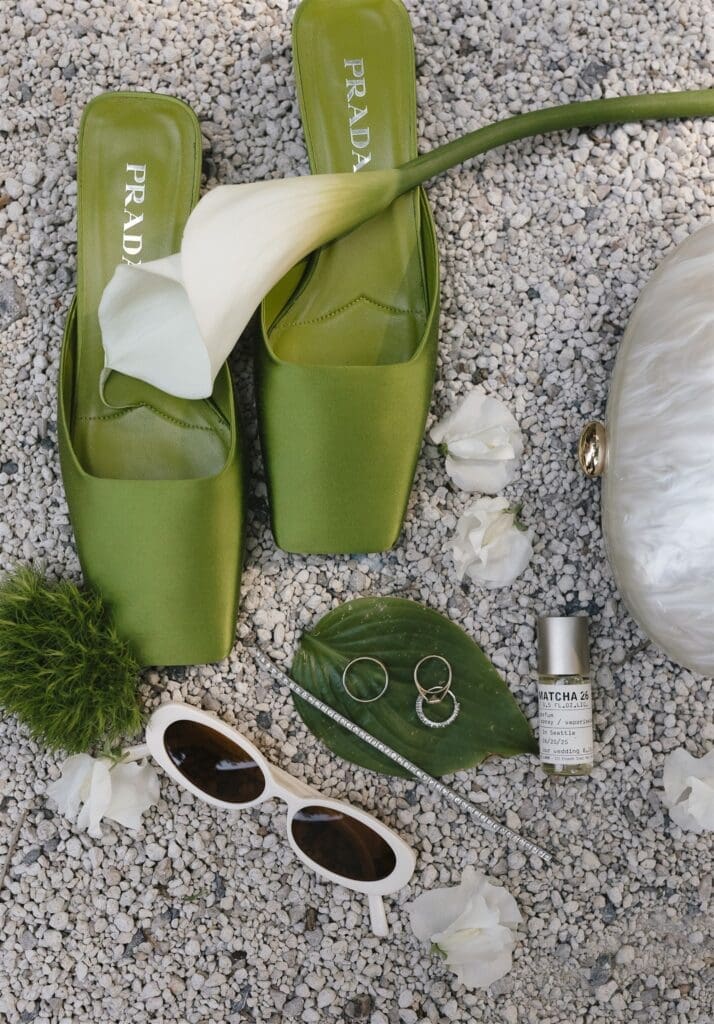 Green Prada wedding shoes with a flat lay of wedding accessories