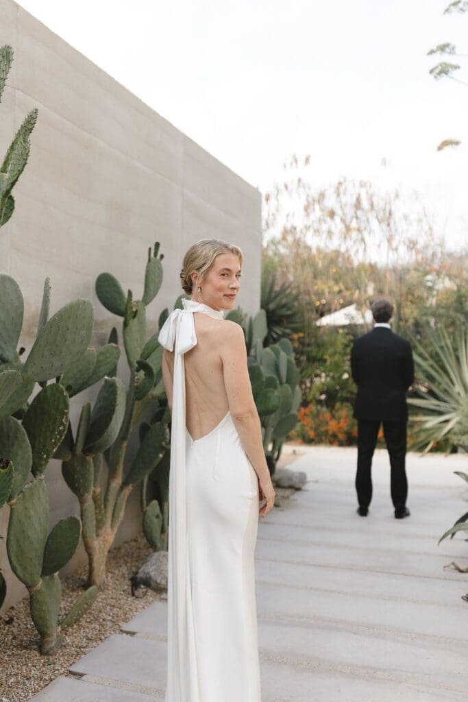 Bride and groom first look near cacti at Acre Resort