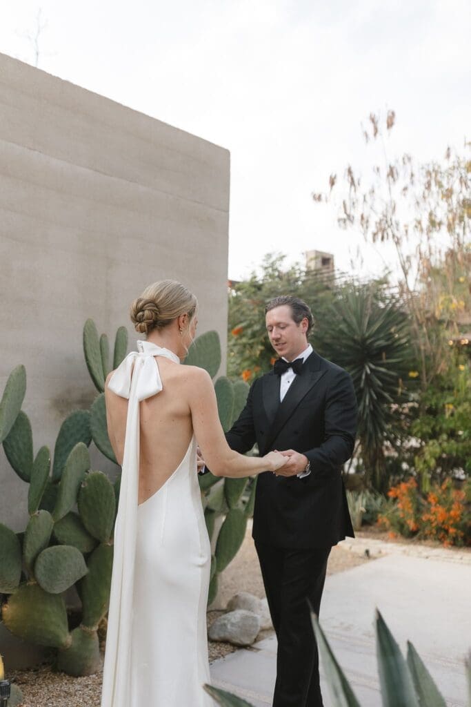 Bride and groom first look near cacti at Acre Resort