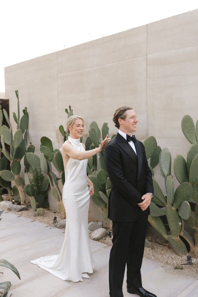 Bride and groom first look near cacti at Acre Resort