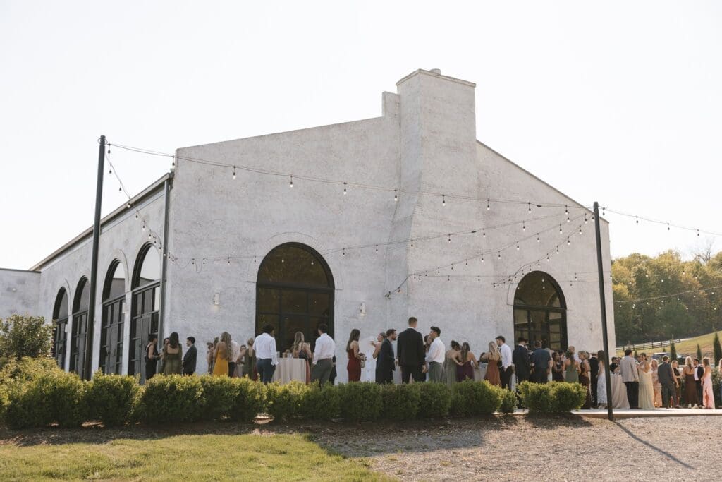 Guests gather during cocktail hour outside of Howe Farms, Chattanooga, Tennessee wedding venue