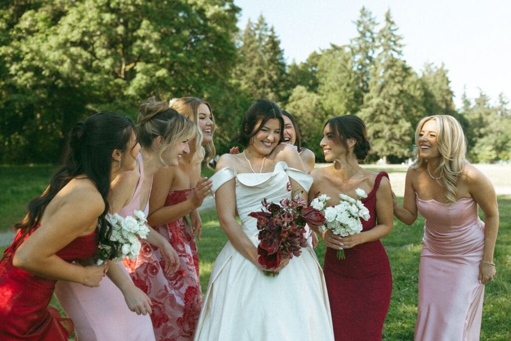 Bride and her bridesmaids giggling together